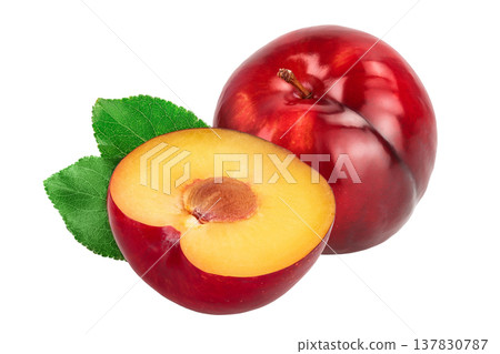 fresh red plum half with leaves isolated on white background fresh red plum half with leaves isolated on white background 137830787