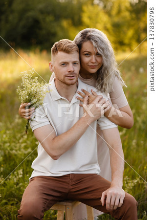 Two Individuals Expressing Tender Feelings Amid Peaceful Outdoor Scenery At Dusk 137830798