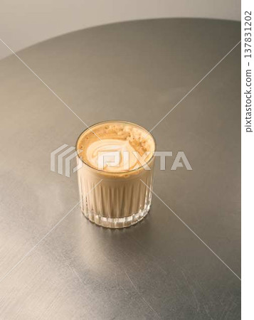 Serene coffee moment. Calm latte with peaceful surroundings Serene coffee moment. Calm latte with peaceful surroundings 137831202