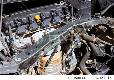 Engine components are visible in car during repair in workshop setting 137831417