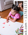 Caucasian young girl drawing with colored pencils on white paper at home 137831573