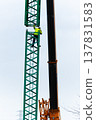 Male worker climbing construction crane on overcast day 137831583