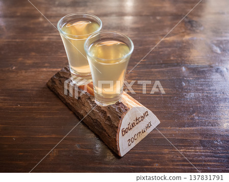 [Ukraine] Two vodka glasses on a wooden table in a restaurant in Lviv, western Ukraine. 137831791