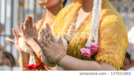Traditional Thai dance close perspective focusing on expressive hand and foot gestures with intricate costume details and cultural performance style. Traditional Thai dance close perspective focusing on expressive hand and foot gestures with intricate costume details and cultural performance style. 137831868