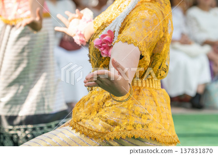 Traditional Thai dance close perspective focusing on expressive hand and foot gestures with intricate costume details and cultural performance style. Traditional Thai dance close perspective focusing on expressive hand and foot gestures with intricate costume details and cultural performance style. 137831870
