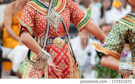 Traditional Thai dance close perspective focusing on expressive hand and foot gestures with intricate costume details and cultural performance style. Traditional Thai dance close perspective focusing on expressive hand and foot gestures with intricate costume details and cultural performance style. 137831872