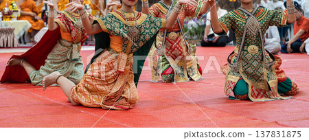 Traditional Thai dance close perspective focusing on expressive hand and foot gestures with intricate costume details and cultural performance style. Traditional Thai dance close perspective focusing on expressive hand and foot gestures with intricate costume details and cultural performance style. 137831875