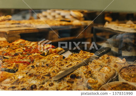 Delicious pizza and focaccia in a traditional bakery. 137831990