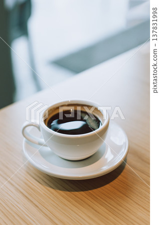 Cup of black coffee on a table in a cafe. 137831998