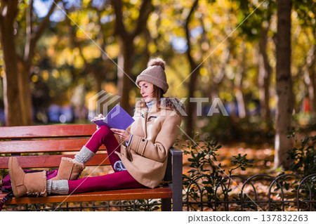 Young Woman with anorexia writing diary in autumn park Young Woman with anorexia writing diary in autumn park 137832263