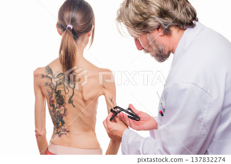 Doctor performing body composition assessment on woman with eating disorder 137832274