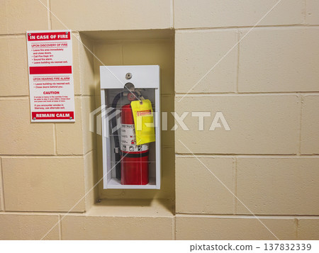 Fire extinguisher and safety sign in hallway Fire extinguisher and safety sign in hallway 137832339