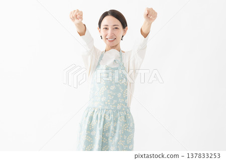 Woman wearing an apron Lifestyle image Woman wearing an apron Lifestyle image 137833253