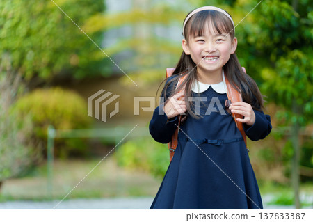 Girls carrying a school bag Girls carrying a school bag 137833387