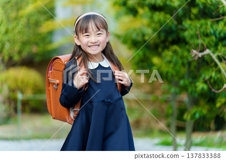Girls carrying a school bag Girls carrying a school bag 137833388