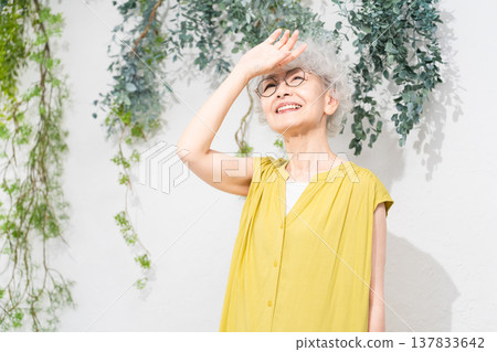 Senior woman wearing a yellow dress Senior woman wearing a yellow dress 137833642