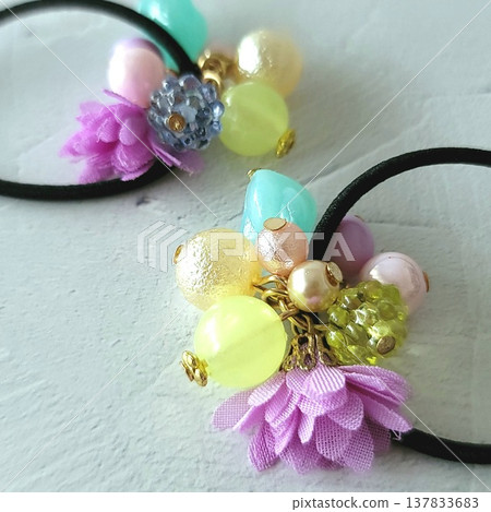 Handmade kids' hair tie with lots of colorful beads and a frilly flower design. 137833683