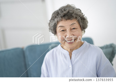 Senior woman looking at camera and smiling Senior woman looking at camera and smiling 137833955