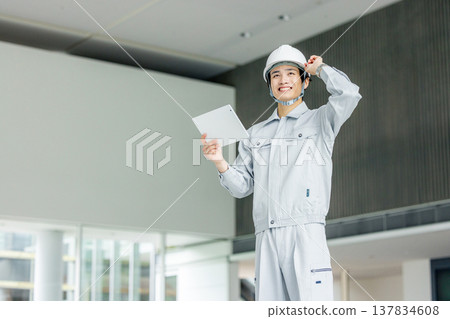 Male worker holding a tablet Male worker holding a tablet 137834608