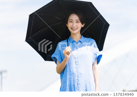 A young woman walking with a parasol Lifestyle image 137834940