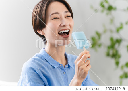 Young woman eating ice cream lifestyle image 137834949
