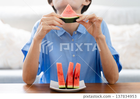 Young woman eating watermelon lifestyle image Young woman eating watermelon lifestyle image 137834953