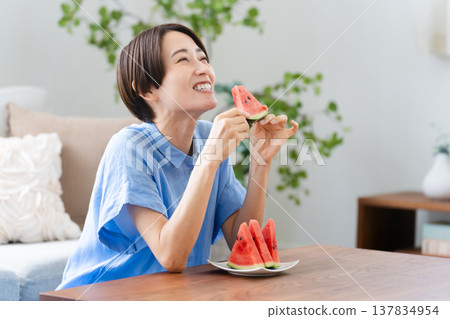 Young woman eating watermelon lifestyle image Young woman eating watermelon lifestyle image 137834954