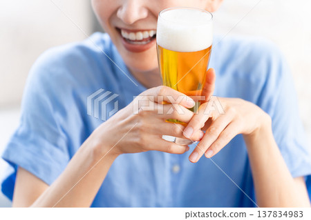 Young woman drinking beer lifestyle image Young woman drinking beer lifestyle image 137834983