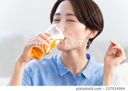Young woman drinking beer lifestyle image Young woman drinking beer lifestyle image 137834984