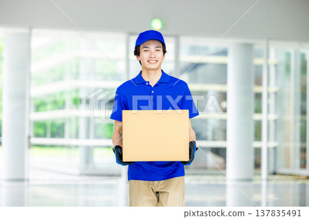 A man with a smile carrying baggage A man with a smile carrying baggage 137835491
