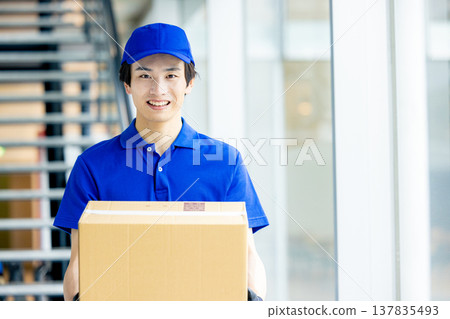 A man with a smile carrying baggage A man with a smile carrying baggage 137835493