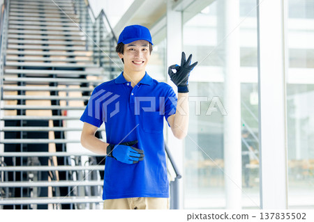 Image of a blue-clad worker in a warehouse Image of a blue-clad worker in a warehouse 137835502