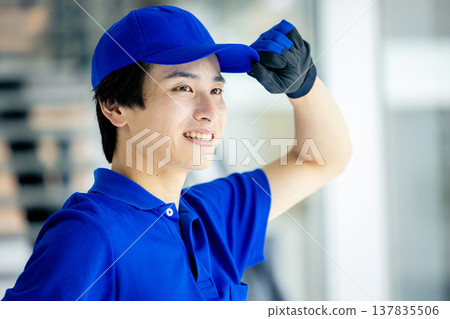 Image of a blue-clad worker in a warehouse Image of a blue-clad worker in a warehouse 137835506