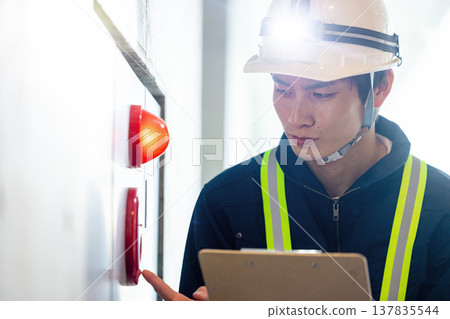 A man conducting a fire safety inspection A man conducting a fire safety inspection 137835544