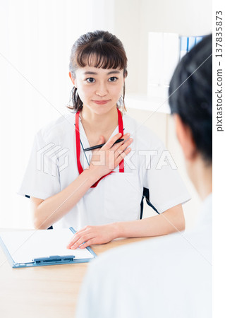Healthcare worker explaining to patient Healthcare worker explaining to patient 137835873