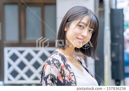 A woman wearing a floral dress 137836236