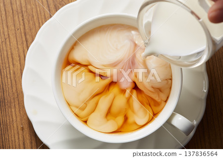 Adding milk to tea Adding milk to tea 137836564