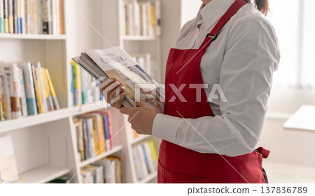 Salesperson with a catalog 137836789