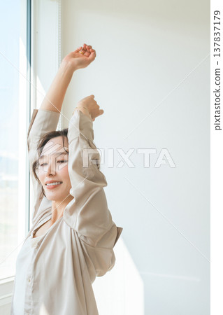 A woman by the window in the setting sun (model, fashion, light, shadow) A woman by the window in the setting sun (model, fashion, light, shadow) 137837179