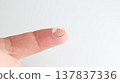 A hard contact lens placed on the index finger. 137837336