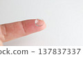 A hard contact lens placed on the index finger. 137837337