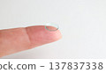 A hard contact lens placed on the index finger. 137837338