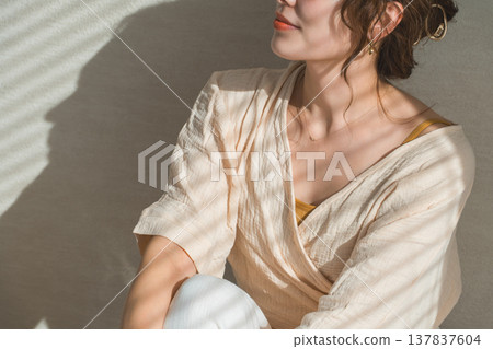 A woman by the window in the setting sun (model, fashion, light, shadow) A woman by the window in the setting sun (model, fashion, light, shadow) 137837604