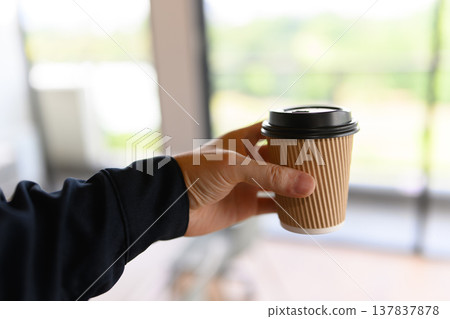 Hand with coffee cup Hand with coffee cup 137837878