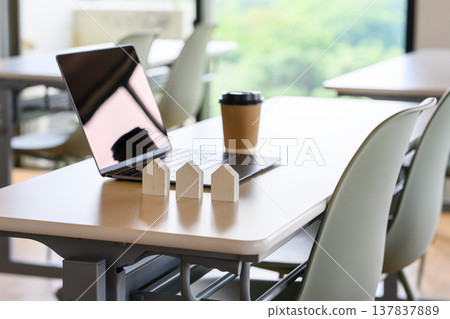 House models and a computer lined up on the desk House models and a computer lined up on the desk 137837889