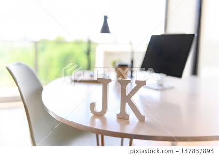 The letters "JK" are placed on the desk. The letters "JK" are placed on the desk. 137837893