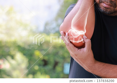 Professional photo of distressed middle-aged man holding his painful right elbow with a medical visualization of glowing bone and inflammation in a green park environment. Concept of pain and injury. Professional photo of distressed middle-aged man holding his painful right elbow with a medical visualization of glowing bone and inflammation in a green park environment. Concept of pain and injury. 137838200