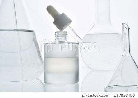 Modern laboratory skincare concept with glass dropper and cosmetic serum bottle 137838490