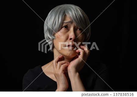 A sad-looking senior woman with white hair A sad-looking senior woman with white hair 137838516
