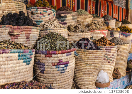 Herbal teas and medicinal herbs displayed in woven baskets at traditional Egyptian market 137838608